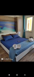a bedroom with two beds with blue pillows at Mar&Mar in Alghero