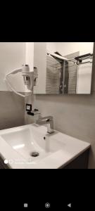 a white sink in a bathroom with a mirror at Mar&Mar in Alghero