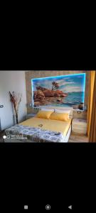 a bedroom with a bed with a painting on the wall at Mar&Mar in Alghero