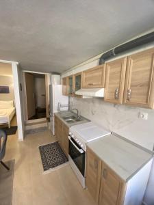 a kitchen with a sink and a stove top oven at Yellow Submarine in Skala Fourkas