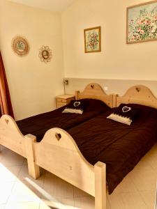 a bedroom with a large wooden bed in a room at Lozari Beach in Belgodère