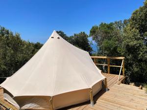 a white tent sitting on top of a wooden deck at CORSICA NATURA #1 in Coti-Chiavari