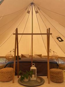 a tent with a bed in it with two chairs at CORSICA NATURA #1 in Coti-Chiavari