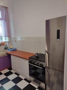 a kitchen with a stove and a refrigerator at Комната pilika 4room with shared bath in Athens