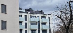 a white building with balconies on the side of it at Apartament Wyłom 8 in Poznań