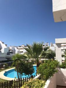a view of the pool from the balcony of a apartment at Apartamento en islantilla in Islantilla