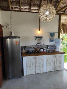 a kitchen with a stainless steel refrigerator and a counter at Chill Kite - Icaraí Kite Village in Icaraí