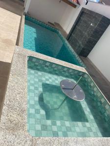 a swimming pool with a clock in the middle of it at HOTEL IMPERIO in Aparecida do Taboado +16 photos