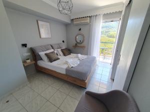 a bedroom with a bed and a large window at Mare blu Lefkada in Nydri