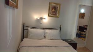 A bed or beds in a room at Flora's Boutique Apartment at the heart of Corfu