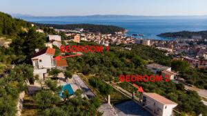 an aerial view of a city with the words bedroom and a house at Olive Stone House in Makarska