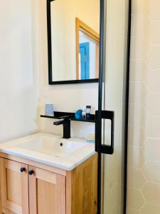 a bathroom with a sink and a mirror at Jakaranda Unique Apart in Bodrum City