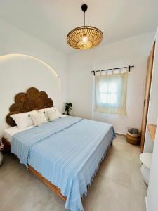 a bedroom with a large bed with a blue blanket at Jakaranda Unique Apart in Bodrum City