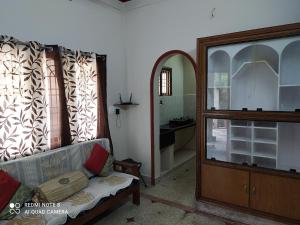 a living room with a couch and a mirror at Anve's Airport Nest in Visakhapatnam
