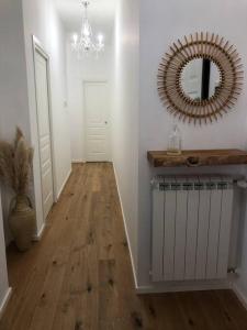 a hallway with a mirror and a wooden floor at Casa Porto Turistico in Licata