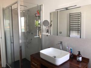a bathroom with a sink and a shower at Casa Porto Turistico in Licata