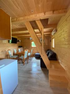 a kitchen and dining room with a staircase in a log cabin at Brunarica Jeršin in Cerkno