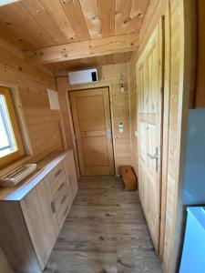 a small room in a wooden cabin with a door at Brunarica Jeršin in Cerkno