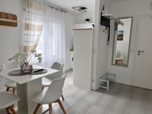 a white dining room with a table and chairs at Prime Host Style Apartment in Karlsruhe