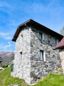 a stone building with windows on the side of it at Alex Chalet in Cavia