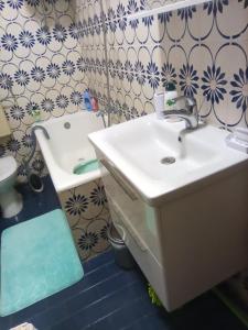 a bathroom with a sink and a toilet and a tub at Apartmani Mislav in Slatine