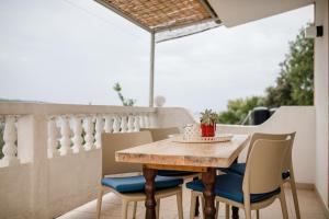 a wooden table and chairs on a balcony at Apartments Kos in Supetarska Draga