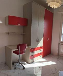 an office with a red chair and a desk and cabinets at Ritiro sul fiume Mantova, Cremona Circuit in Canneto sullʼOglio