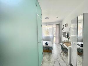a room with a desk and a room with a table at GlassRoom- Самостоятелна стая Private room in Varna City