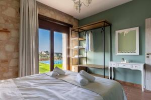 a bedroom with a large bed and a window at Villa Õtium in Epáno Váthia +27 photos