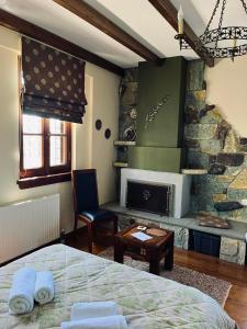 a bedroom with a bed and a fireplace at Giagia Evgenia in Vitsa