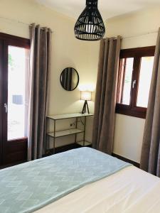 sypialnia z łóżkiem, stołem i oknami w obiekcie Sunset Bay w mieście Porto Heli
