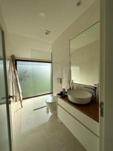 a white bathroom with a sink and a toilet at Casa do Forno de Cal in Vila do Conde