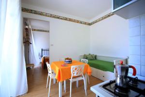 a small kitchen with a table and a bed in a room at Pupi Catania Etna B&B - #viaggiosiciliano in Catania