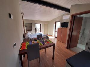 a living room with a table and a bed at Casa castel in Gargnano