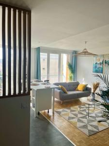 a living room with a couch and a table at Chambre privée dans un appartement partagé in Villeurbanne