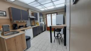 a kitchen with a sink and a table in it at Maison Chez Lili à 200 m de la plage ,jardin privé et clos in Gravelines +35 photos