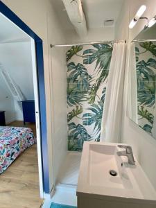 a bathroom with a sink and a shower and a bed at Maison avec piscine au calme 