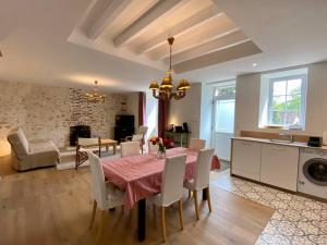 a kitchen and dining room with a table and chairs at Maison avec piscine au calme 