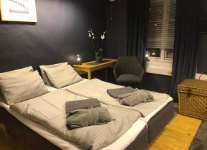 a bedroom with a large bed with two pillows on it at Taras Rom og leiligheter in Kragerø