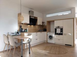 a kitchen with a table and chairs and a microwave at Ferienwohnung Naturpark Schwarzwald in Löffingen