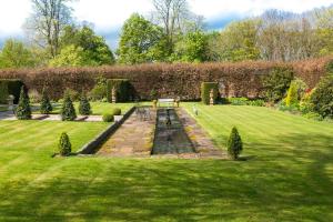 a garden with a bench in the grass at Calthwaite Hall Bed & Breakfast in Penrith