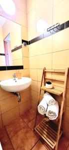 a bathroom with a sink and a mirror and towels at Kokosek Pokoje Gościnne in Mielno +103 photos