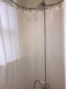 a bathroom with a shower with a shower curtain at Walk to Bay Street and Historic Downtown Beaufort! Close to Parris Island MCRD!! in Beaufort