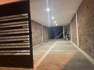 an empty hallway with a brick wall and a staircase at TWO bedroom apartment 101 in Mazatlán