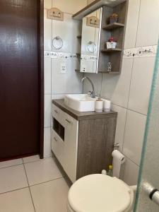 a small bathroom with a toilet and a sink at Mountain House in Bom Jardim da Serra