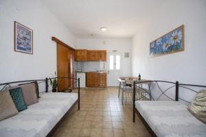 a living room with a couch and a table at NORMA'S VILLAGE in Kalymnos