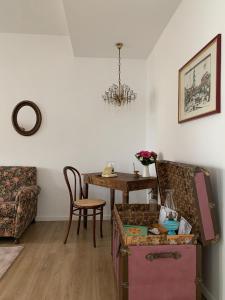 a living room with a table and a chair at Mariluna in Modugno