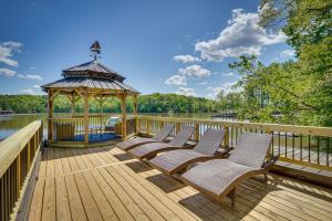 a group of chairs sitting on a deck with a gazebo at Lakefront Vacation Rental with Views and Hot Tub! in Bracey