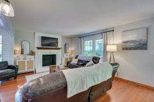 a living room with a leather couch and a fireplace at Lakefront Vacation Rental with Views and Hot Tub! in Bracey