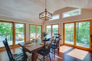 a dining room with a table and chairs at Lakefront Vacation Rental with Views and Hot Tub! in Bracey